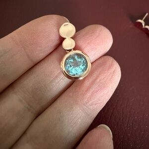 Rose gold color drop earrings with blue stone